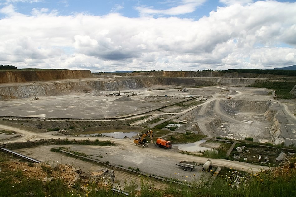 Large quarry with excavators and trucks