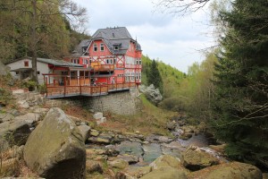 Half-timbered house on the edge of the forest with stream