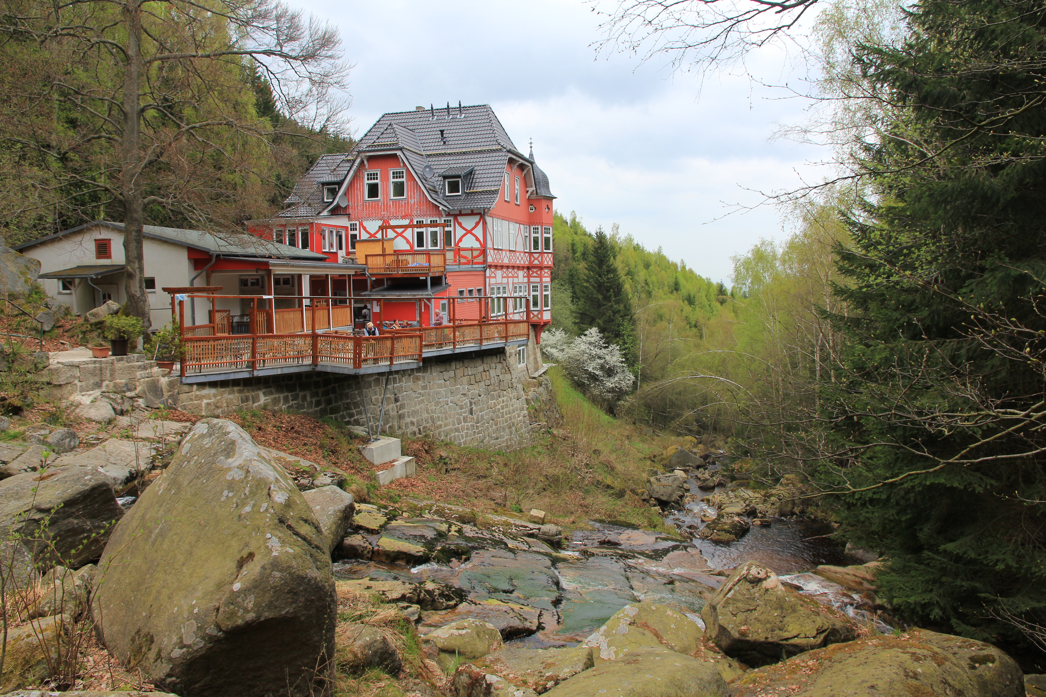 Half-timbered house on the edge of the forest with stream