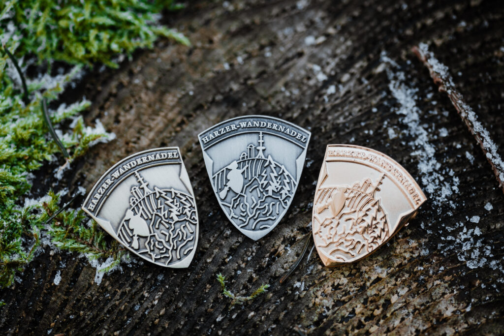 Three Harz hiking needles on a wooden surface
